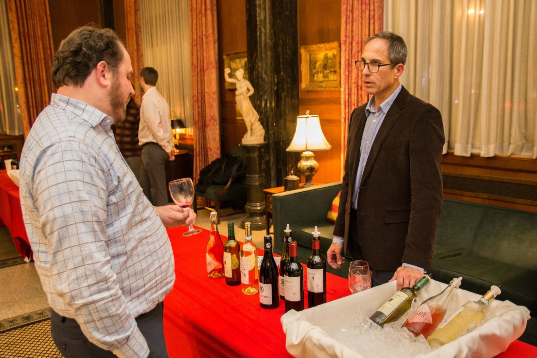 An attendee talks with a wine representative at the event